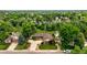 Charming single-story home surrounded by lush greenery featuring a curved driveway and well-manicured lawn at 5292 W Fair Dr, Littleton, CO 80123