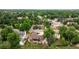 An aerial view shows the home nestled among lush trees, highlighting the expansive neighborhood at 5292 W Fair Dr, Littleton, CO 80123