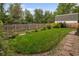 Landscaped backyard with green lawn, stone pathway, flowers, and privacy fence at 5292 W Fair Dr, Littleton, CO 80123