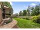 Expansive backyard features lush lawn, mature trees, garden beds, and patio area perfect for outdoor entertaining at 5292 W Fair Dr, Littleton, CO 80123