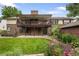 Spacious backyard featuring a covered deck, patio, and lush lawn at 5292 W Fair Dr, Littleton, CO 80123