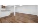 Spacious finished basement with wood-look flooring, bar area, and open layout at 5292 W Fair Dr, Littleton, CO 80123