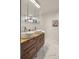 Modern bathroom with dual vessel sinks, wood vanity, and marble floors at 5292 W Fair Dr, Littleton, CO 80123