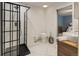 Well-lit bathroom with a walk-in shower, double sinks, and a view of the primary bedroom at 5292 W Fair Dr, Littleton, CO 80123