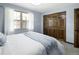 Bright bedroom featuring a large window, white curtains, closet and a comfortable bed at 5292 W Fair Dr, Littleton, CO 80123