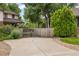 Wide concrete driveway with parking area, bordered by mature landscaping and a privacy fence at 5292 W Fair Dr, Littleton, CO 80123