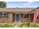 Charming front exterior of a brick home featuring a stylish blue door and well-maintained landscaping at 5292 W Fair Dr, Littleton, CO 80123