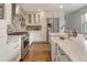 Bright kitchen with white cabinets, stainless steel appliances, and a clean, modern aesthetic at 5292 W Fair Dr, Littleton, CO 80123