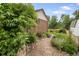 Lush garden beds with stone path enhance the appeal of the brick home, creating a tranquil outdoor space at 5292 W Fair Dr, Littleton, CO 80123