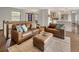Inviting living room with hardwood floors, leather seating, and a seamless flow into the modern kitchen at 5292 W Fair Dr, Littleton, CO 80123