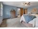 Comfortable main bedroom featuring a ceiling fan, barn door to bath, and ample space at 5292 W Fair Dr, Littleton, CO 80123