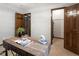 Home office featuring wooden desk, hardwood doors, and neutral color palette at 5292 W Fair Dr, Littleton, CO 80123