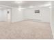 Spacious carpeted basement area with natural light from a window, perfect for recreation or storage at 591 Nome St, Aurora, CO 80010