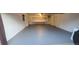 Large open garage with painted floor and shelves at 591 Nome St, Aurora, CO 80010
