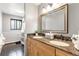 Updated bathroom featuring a double sink vanity with granite counters and tiled floors at 591 Nome St, Aurora, CO 80010