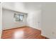 Bright bedroom showcasing hardwood floors, a window, and closet doors at 591 Nome St, Aurora, CO 80010
