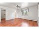Bright bedroom featuring gleaming hardwood floors, ceiling fan, and a sunlit window at 591 Nome St, Aurora, CO 80010