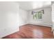 Inviting bedroom with hardwood floors and natural light from the window; offers a comfortable retreat at 591 Nome St, Aurora, CO 80010