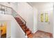 Welcoming entrance boasts hardwood stairs, wrought iron railings, and decorative glass on the front door at 591 Nome St, Aurora, CO 80010