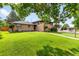 Charming home with mature trees and lush green lawn at 591 Nome St, Aurora, CO 80010