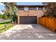 Two-story brick home with attached garage and a long driveway at 591 Nome St, Aurora, CO 80010