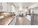 Open-concept kitchen seamlessly flows into the dining area, ideal for entertaining and everyday living at 591 Nome St, Aurora, CO 80010
