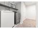 Functional laundry room with modern washer and dryer units, plus ample space for folding and storage at 591 Nome St, Aurora, CO 80010