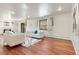 Spacious living room with hardwood floors, white sofas, and ample space for entertaining at 591 Nome St, Aurora, CO 80010
