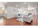 Spacious living room offers hardwood floors, white walls, and recessed lighting providing a modern look at 591 Nome St, Aurora, CO 80010