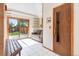 Bright entryway with white tile floor, a wood bench, and a sliding glass door to the yard at 591 Nome St, Aurora, CO 80010