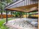 Covered outdoor patio with tiled flooring, iron posts and detailed ceiling design at 591 Nome St, Aurora, CO 80010