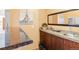 A cozy wet bar area featuring a marble countertop, dark wood cabinetry, and modern fixtures at 591 Nome St, Aurora, CO 80010