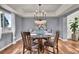 Formal dining room with hardwood floors, chandelier, and glass-top table at 1607 Rosedale St, Castle Rock, CO 80104