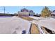 Two-story home with a three-car garage and snowy yard at 1607 Rosedale St, Castle Rock, CO 80104