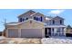 Two-story house with gray siding, three-car garage, and snowy front yard at 1607 Rosedale St, Castle Rock, CO 80104