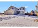 Two-story house with gray siding, three-car garage, and snowy front yard at 1607 Rosedale St, Castle Rock, CO 80104