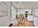 Eat-in kitchen with white cabinets, granite counters, and hardwood floors at 1607 Rosedale St, Castle Rock, CO 80104