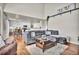 Spacious living room with hardwood floors, large sectional sofa, and a view into the kitchen at 1607 Rosedale St, Castle Rock, CO 80104