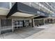 A sleek building entrance with a black awning that reads 