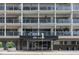 Modern condo facade with balconies, a black awning with 