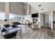 Stylish living room with vaulted ceilings, fireplace, and large windows at 888 N Logan St # 2E, Denver, CO 80203