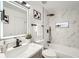 Spa-like bathroom with marble tile, a soaking tub, and modern fixtures at 1825 Kendall St # 101, Lakewood, CO 80214