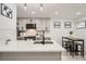 Modern kitchen with gray cabinets, white countertops, and breakfast bar at 1825 Kendall St # 101, Lakewood, CO 80214