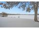 Snowy landscape with a frozen lake and city skyline at 1825 Kendall St # 101, Lakewood, CO 80214