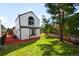 Exterior view of the home highlighting the large backyard and lush green lawn at 9654 W Elmhurst Pl, Littleton, CO 80128