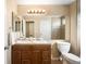 Bathroom featuring a double sink vanity, tiled floor, and shower over the bath at 9654 W Elmhurst Pl, Littleton, CO 80128