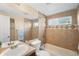 Full bathroom showcasing a tiled shower/tub, double sinks, and decorative accents at 9654 W Elmhurst Pl, Littleton, CO 80128