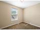 Bright bedroom featuring neutral paint and carpet with a window providing natural light at 9654 W Elmhurst Pl, Littleton, CO 80128