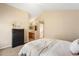 Bedroom with a peek into the ensuite bathroom, with neutral decor and vaulted ceiling at 9654 W Elmhurst Pl, Littleton, CO 80128