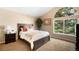 Bright bedroom with a large window, vaulted ceiling, and plush carpet flooring at 9654 W Elmhurst Pl, Littleton, CO 80128